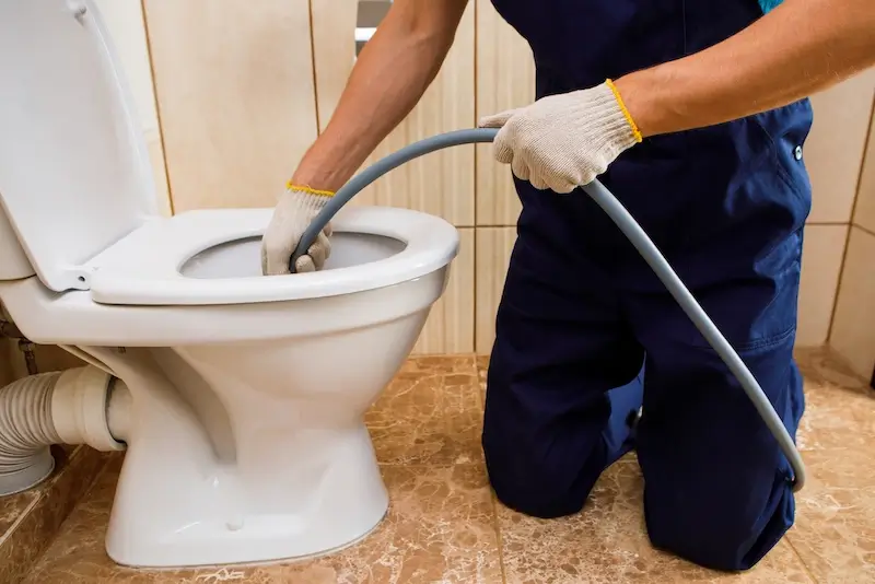 Licensed plumber performing emergency toilet repair in Brisbane