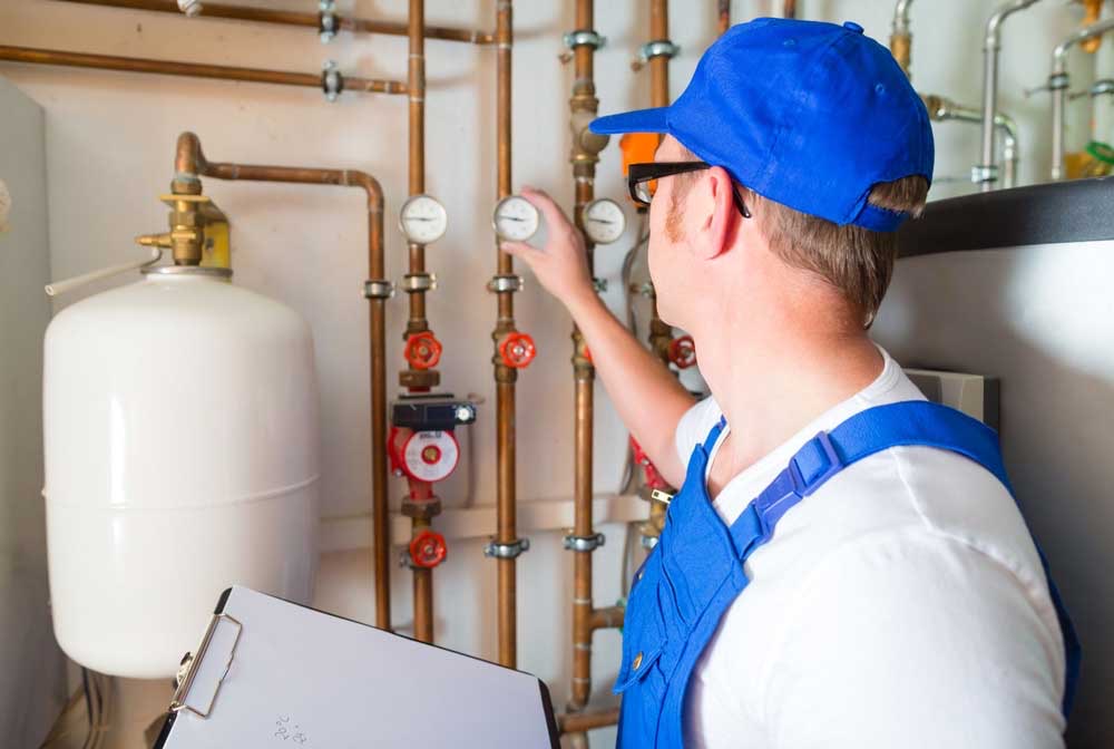 Licensed plumber installing hot water system