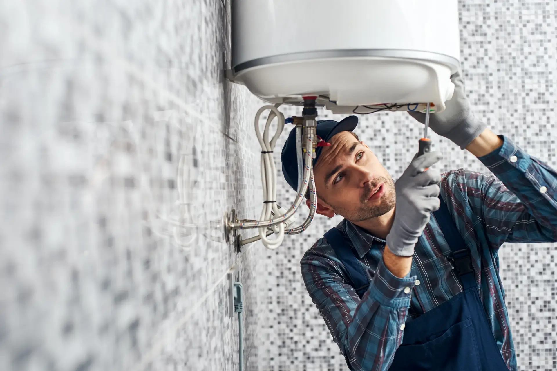 Licensed technician installing and repairing electric heating boiler hot water system