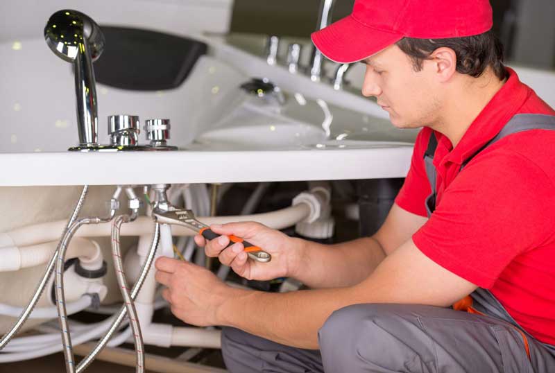 Professional specialist plumber fixing bathroom tap valve and seals