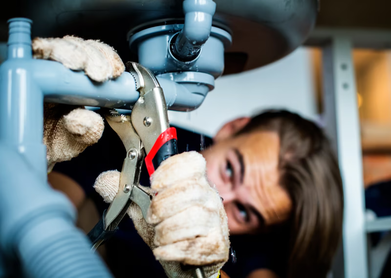 Licensed plumber inspecting pipework and plumbing faults in Algester home