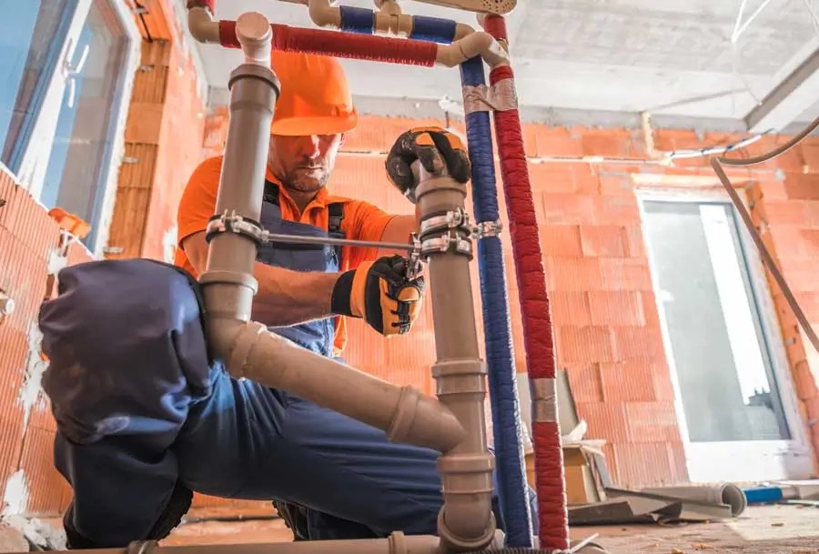 Licensed plumber inspecting pipework and plumbing faults