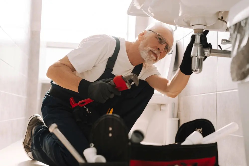 Licensed plumber inspecting pipework and plumbing faults