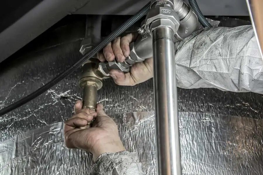 Licensed plumber inspecting pipework and plumbing faults