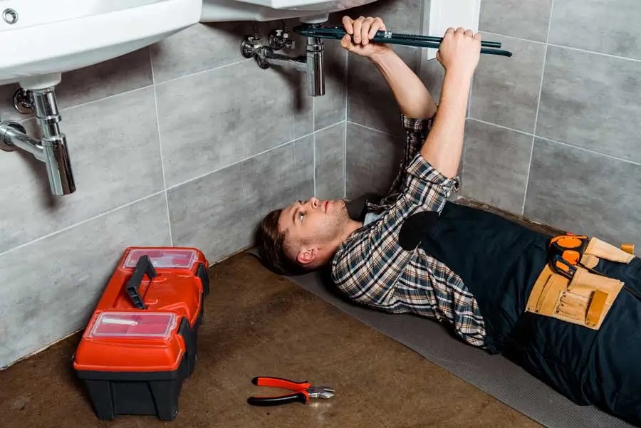 Licensed plumber inspecting pipework and plumbing faults in Morningside home