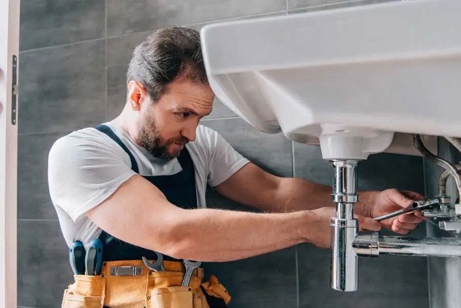 Licensed plumber inspecting pipework and plumbing faults